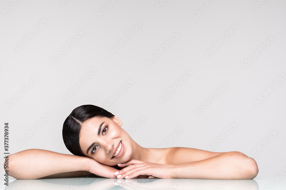 Young pretty woman cosmetics and skincare isolated on gray background Young pretty woman cosmetics and skincare isolated on gray background