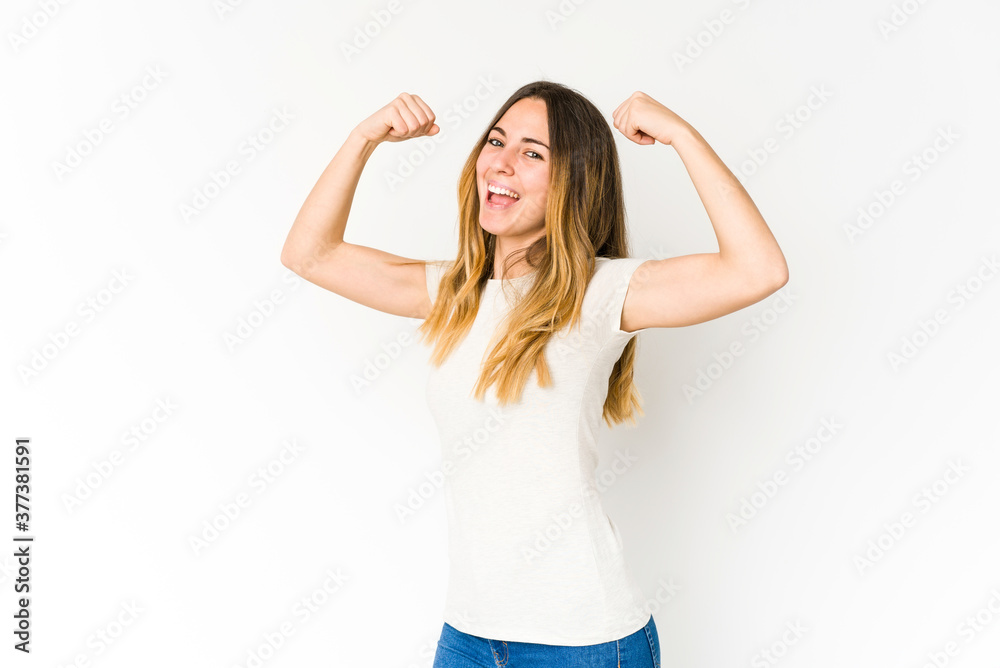 Young caucasian woman isolated on white background raising fist after a victory, winner concept.