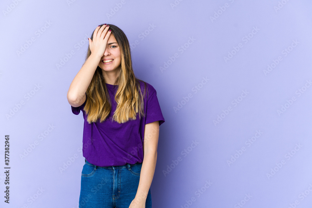 Young caucasian woman isolated on purple background forgetting something, slapping forehead with palm and closing eyes. Young caucasian woman isolated on purple background forgetting something, slapping forehead with palm and closing eyes.