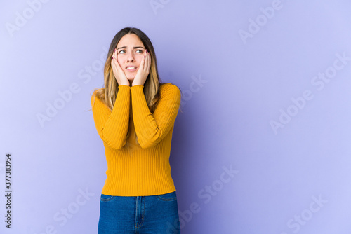 Young caucasian woman isolated on purple background whining and crying disconsolately.