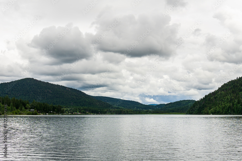 Paul Lake Summer time with green mountains and white clouds british columbia canada. Paul Lake Summer time with green mountains and white clouds british columbia canada.
