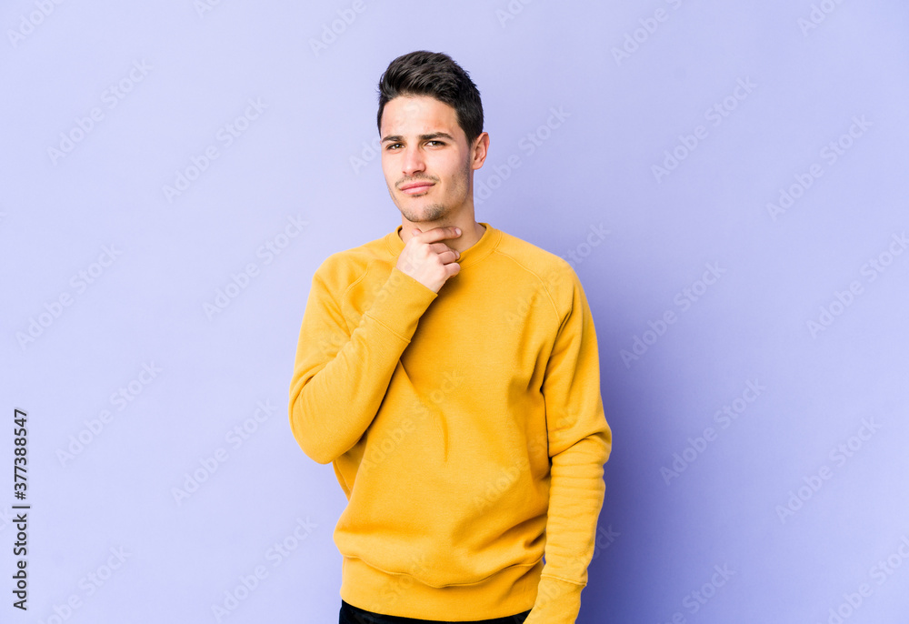 Young caucasian man isolated on purple background suffers pain in throat due a virus or infection. Young caucasian man isolated on purple background suffers pain in throat due a virus or infection.