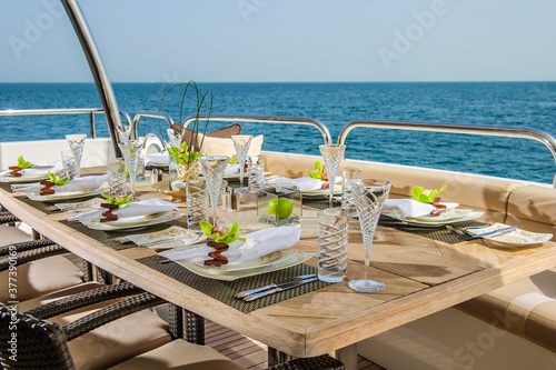 Dinning table on the upper deck in luxurious yacht Fototapet