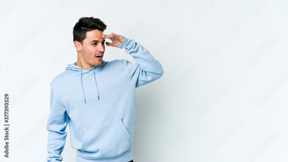 Young caucasian man isolated on white background looking far away keeping hand on forehead. Young caucasian man isolated on white background looking far away keeping hand on forehead.