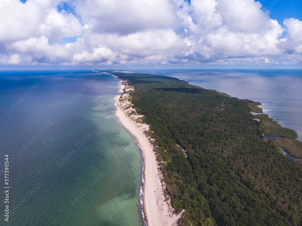 Fototapeta premium Beautiful aerial drone wide view of Curonian spit, Kurshskaya Kosa National Park, Curonian Lagoon and the Baltic Sea, Kaliningrad Oblast, Russia and Klaipeda County, Lithuania, summer sunny day