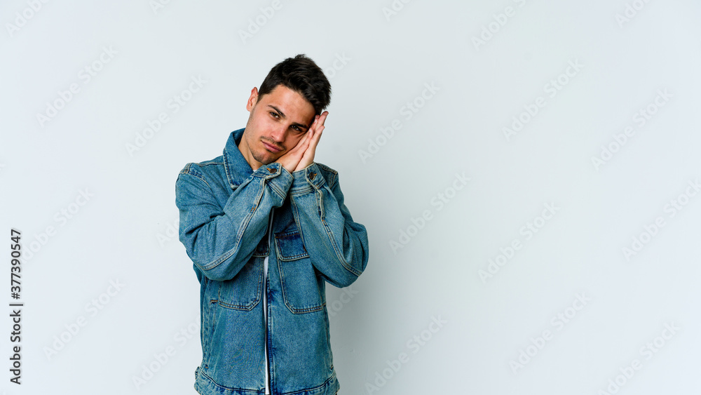 Young caucasian man isolated on white background yawning showing a tired gesture covering mouth with hand. Young caucasian man isolated on white background yawning showing a tired gesture covering mouth with hand.