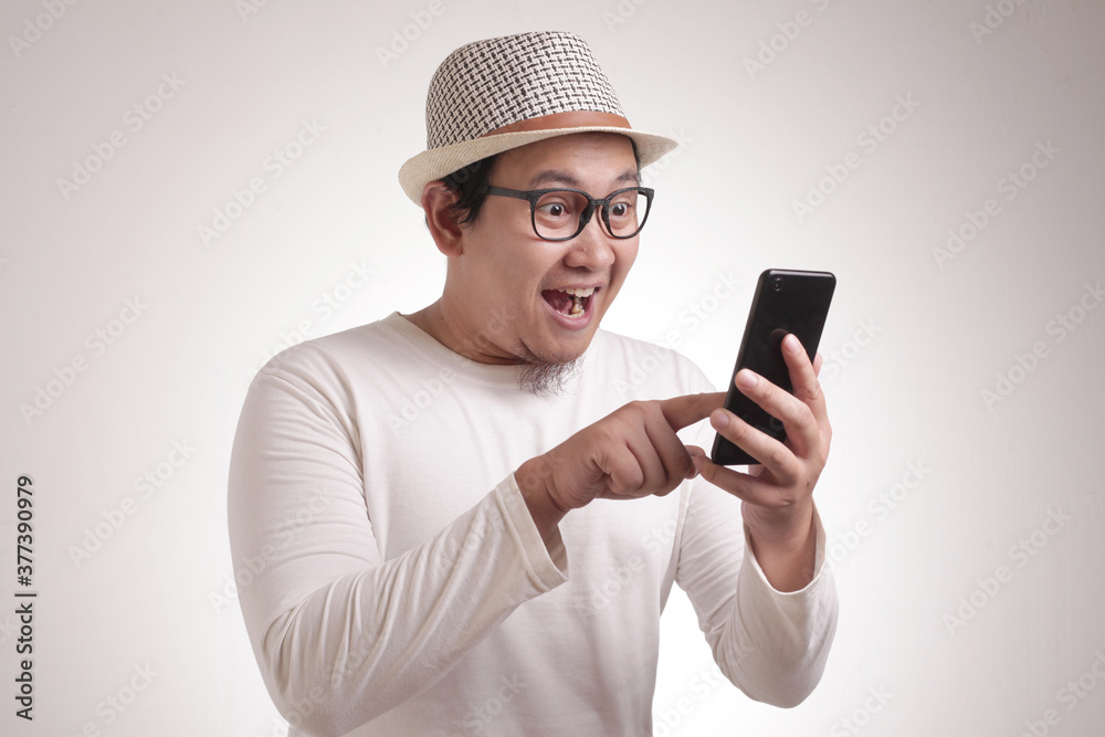 Young Man Texting Reading Chatting on His Phone, Smiling Happy Young Man Texting Reading Chatting on His Phone, Smiling Happy