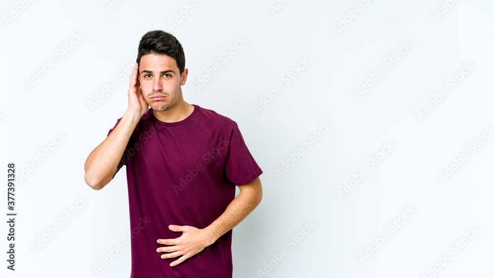 Young caucasian man isolated on white background blows cheeks, has tired expression. Facial expression concept. Young caucasian man isolated on white background blows cheeks, has tired expression. Facial expression concept.