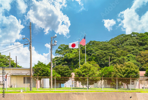 yokosuka, japan - july 19 2020: National flags of Japan and United States of America on the Azuma Island separating the Japan Self Defence Fleet from the american Fleet in the Yokosuka Naval Base. photo