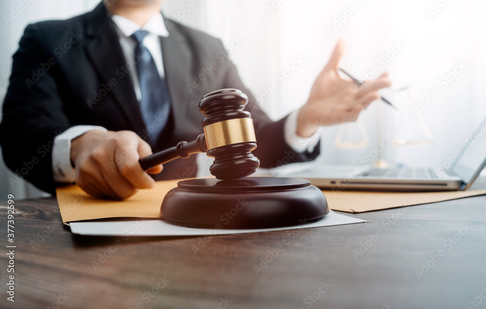 justice and law concept.Male judge in a courtroom on wooden table and Counselor or Male lawyer working in office. Legal law, advice and justice concept. justice and law concept.Male judge in a courtroom on wooden table and Counselor or Male lawyer working in office. Legal law, advice and justice concept.