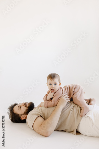 Father and daughter lying and laughing on floor. Daddy and his little girl spending bed time at home. Single dad fun love family lifestyle father's day concept banner