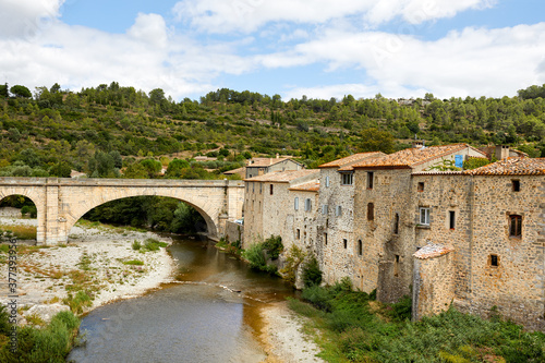 Medieval houses and an old bridge over the river Orbieu in Lagrasse, South of France.