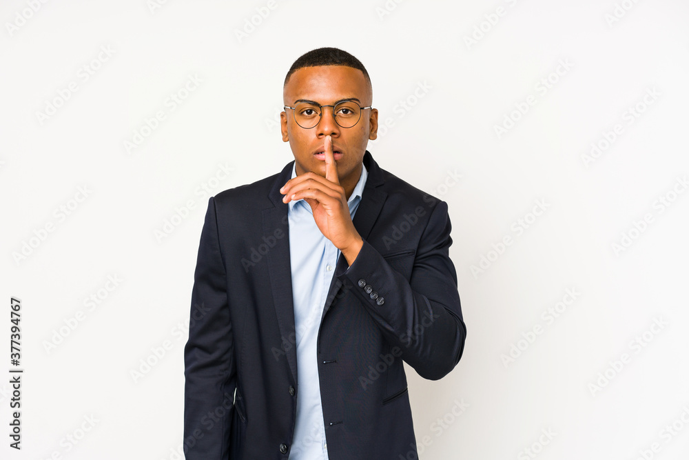 Young business latin man isolated on white background keeping a secret or asking for silence. Young business latin man isolated on white background keeping a secret or asking for silence.