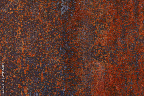 Red-orange coating on metal, rust, old rusty iron, surface, dark. Background, texture.