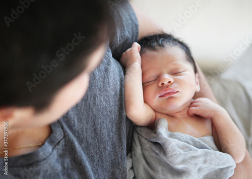 Father Holding Newborn Baby photo