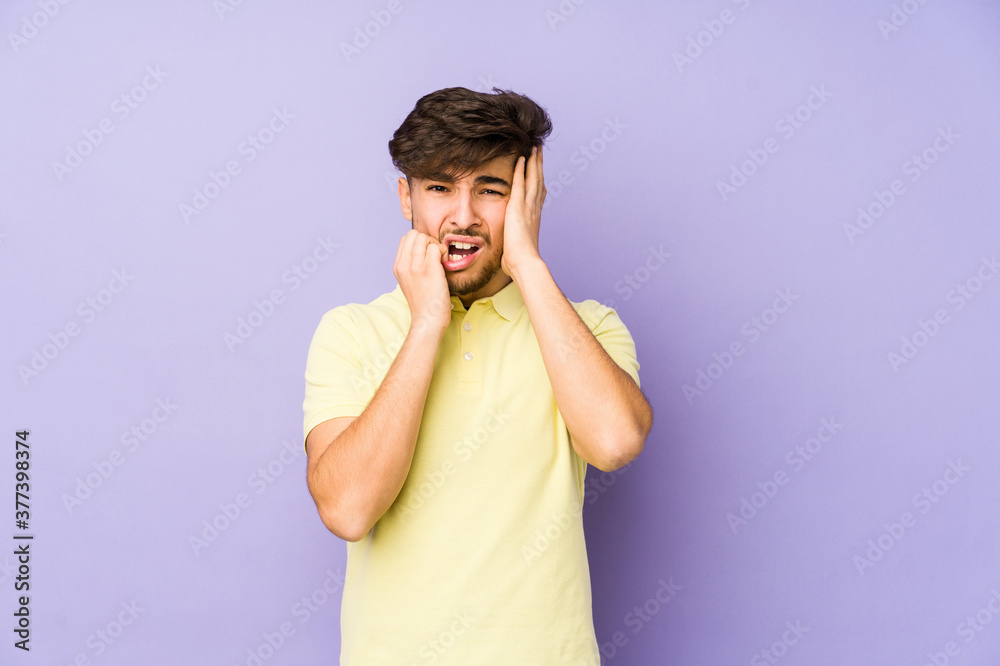 Young arabian man isolated on a purple background whining and crying disconsolately. Young arabian man isolated on a purple background whining and crying disconsolately.