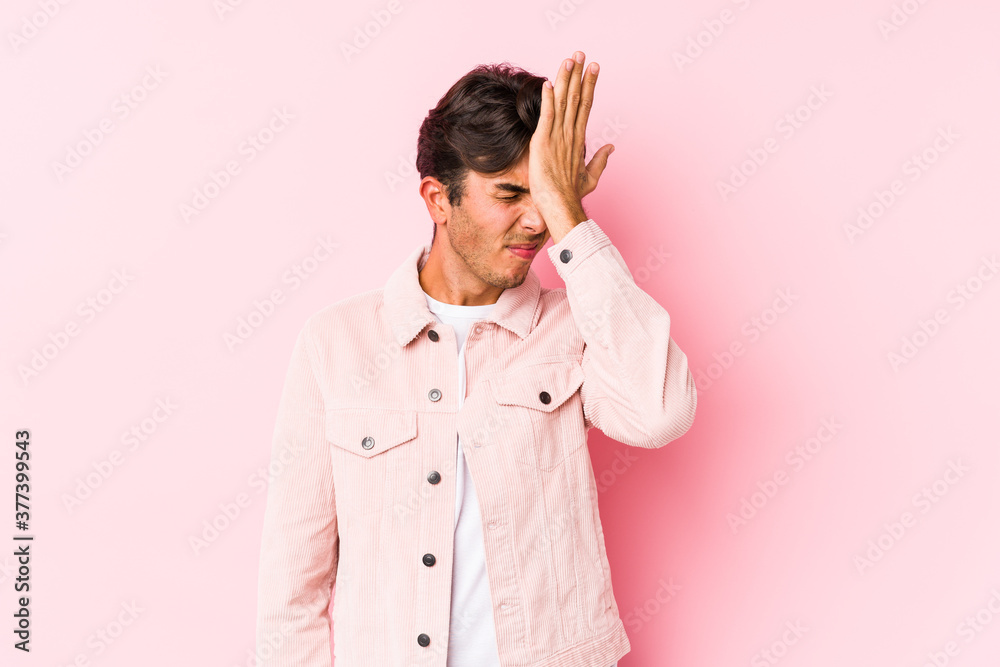 Young caucasian man posing in a pink background isolated forgetting something, slapping forehead with palm and closing eyes. Young caucasian man posing in a pink background isolated forgetting something, slapping forehead with palm and closing eyes.