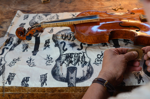 Violin makerViolin maker luthier changing bridge of a handmade baroque