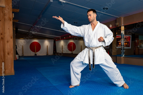 Karate man stand your ground on tatami doing 