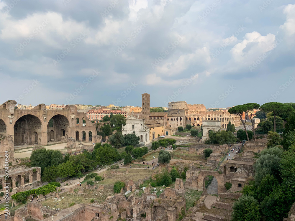 Landscape panoramic view of the Roman Forum - Basilica Nova and The Colosseum in Rome, Italy 