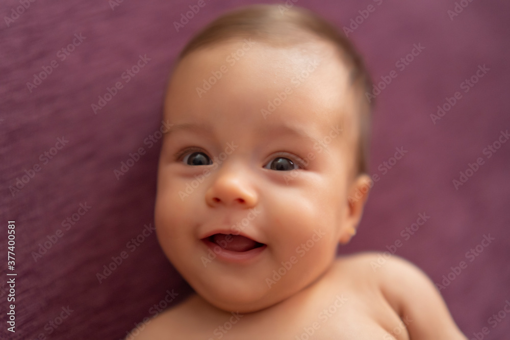 beautiful baby smiling lying on the sofa beautiful baby smiling lying on the sofa