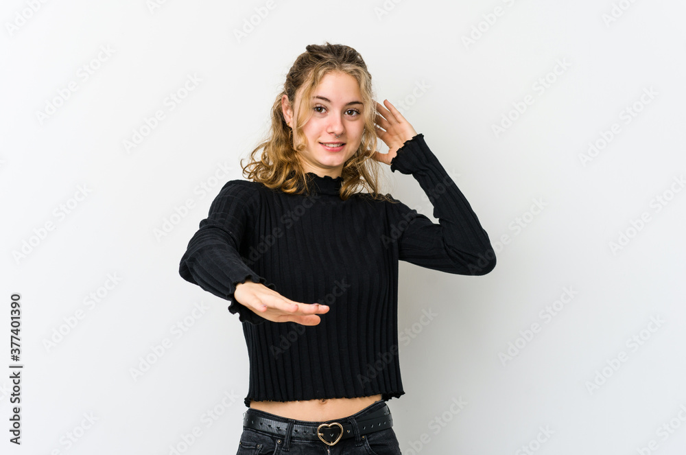 Young caucasian woman on white backrgound being shocked due to an imminent danger