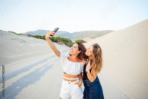 Young women with mobile phones are excited and happy photo