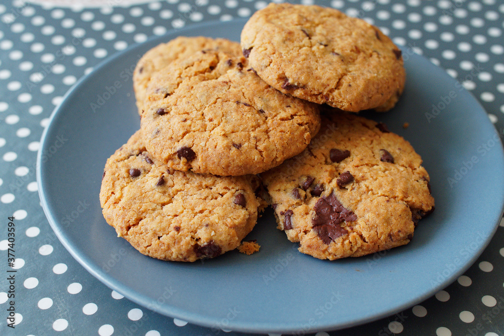 Breakfast at home with the family. Chocolate cookies served on a ceramic plate on the kitchen table. Breakfast at home with the family. Chocolate cookies served on a ceramic plate on the kitchen table.