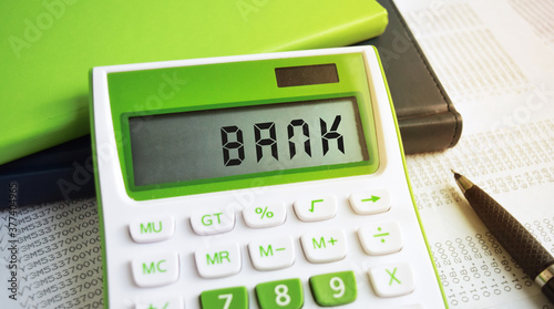 Calculator and book isolated on the desktop. Finance or business concept. Cash and finance. photo