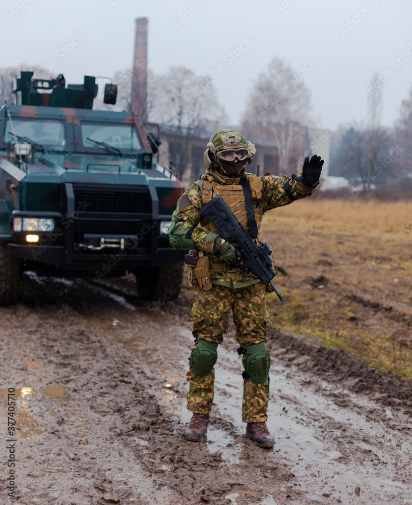 soldier stops the car with a machine gun in his hands soldier stops the car with a machine gun in his hands