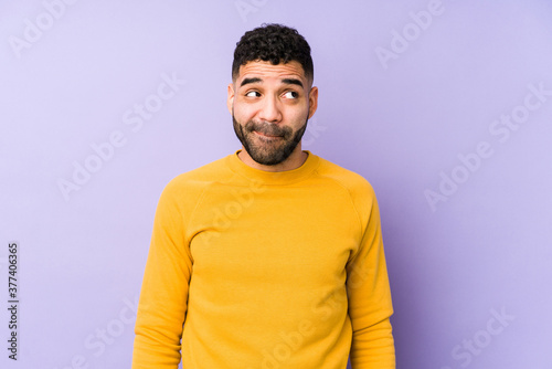 Young mixed race arabic man isolated confused, feels doubtful and unsure.