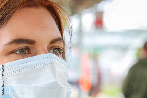 a young woman in a medical mask at the station
