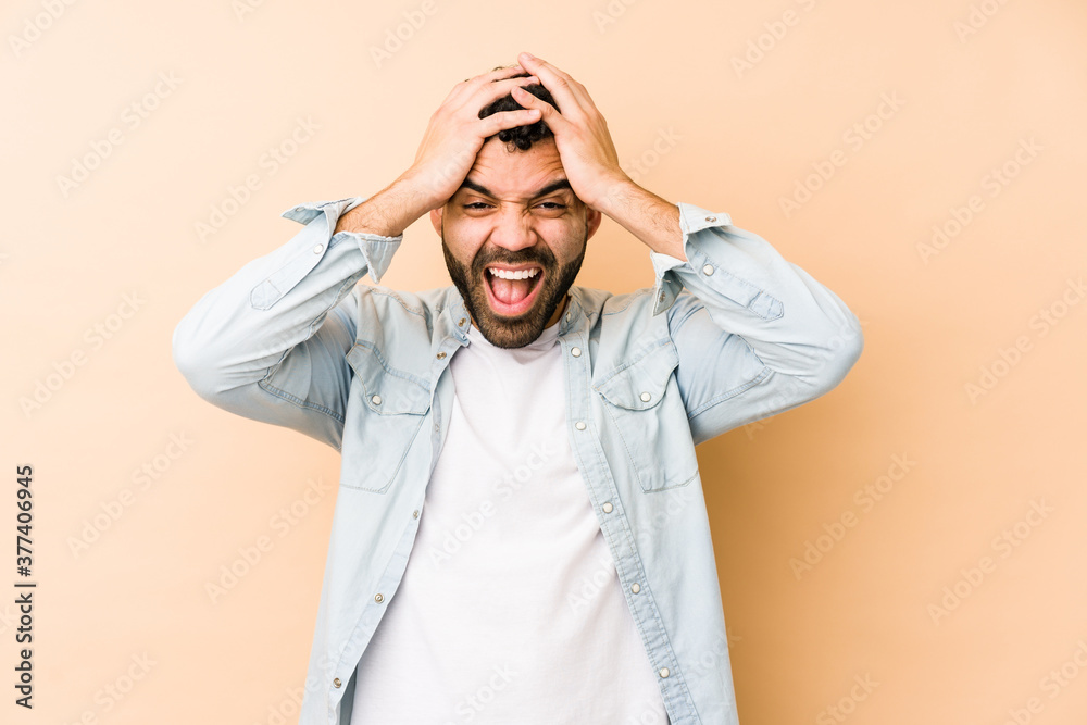 Young mixed race arabic man isolated laughs joyfully keeping hands on head. Happiness concept. Young mixed race arabic man isolated laughs joyfully keeping hands on head. Happiness concept.