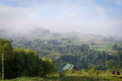 Traditional swiss early autumn view of misty morning in the mountains