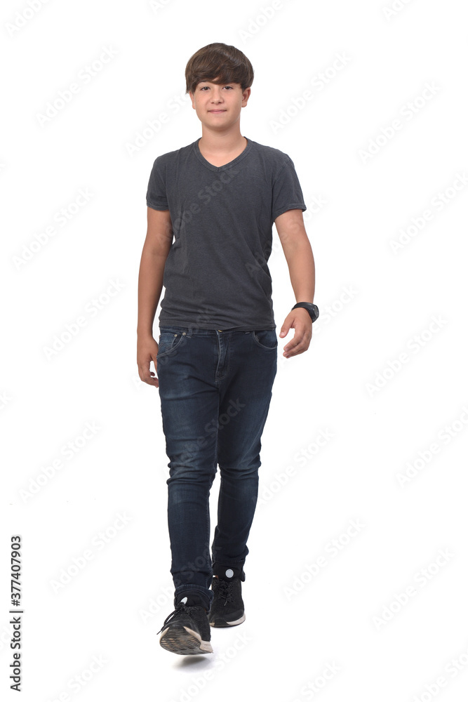 Fototapeta premium portrait of a teenage boy front view walking on white background,