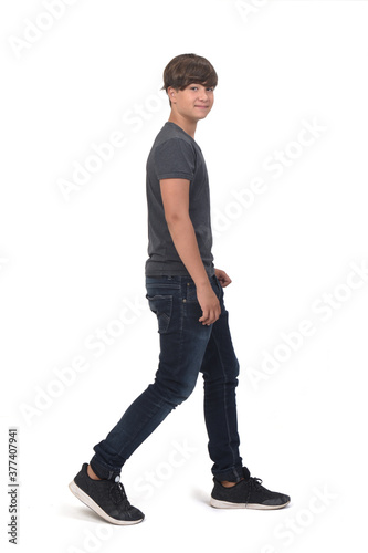 portrait of a teenage side view walking on white background, looking at camera © curto