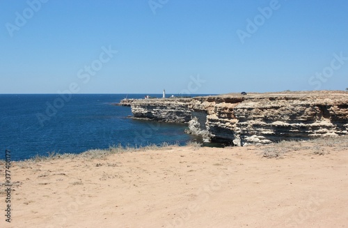 View from the rocky coast of Cape Atlesh to the lighthouse. Western Crimea