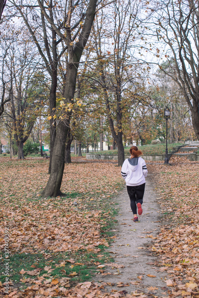 Woman working out in a Autumn park Woman working out in a Autumn park