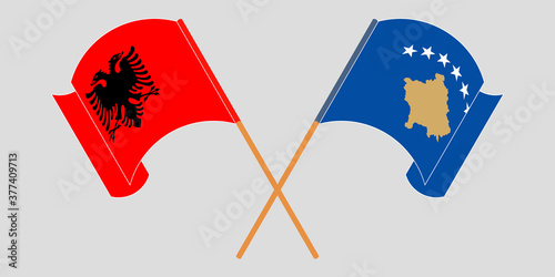 Crossed and waving flags of Kosovo and Albania