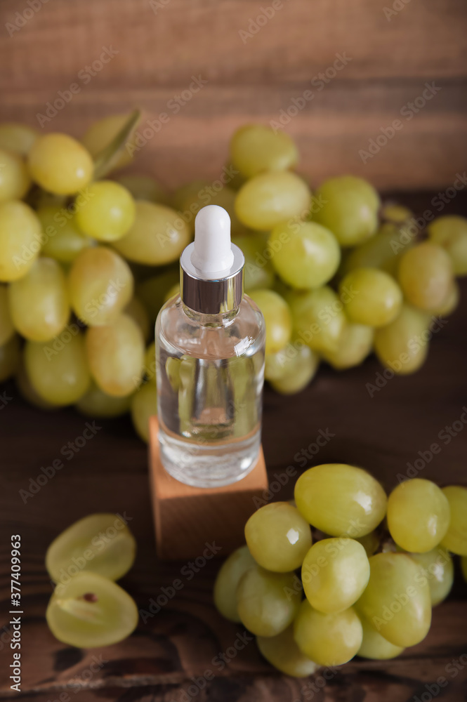 Cold pressed grape oil. Organic bio care products with natural ingredients. Close-up grapes and copy space. Halved grapes and grape seeds. Cold pressed grape oil. Organic bio care products with natural ingredients. Close-up grapes and copy space. Halved grapes and grape seeds.