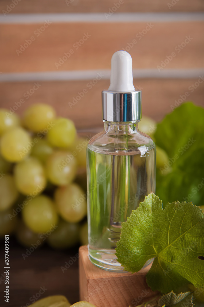 Cold pressed grape oil. Organic bio care products with natural ingredients. Close-up grapes and copy space. Halved grapes and grape seeds.