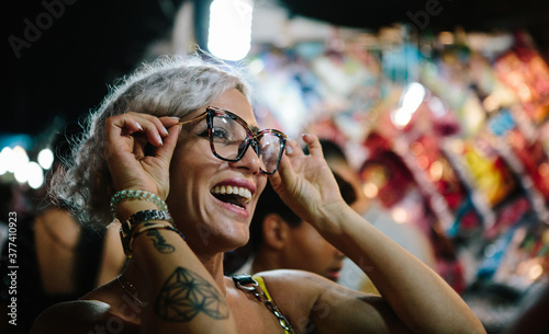 Young woman having fun trying on glasses