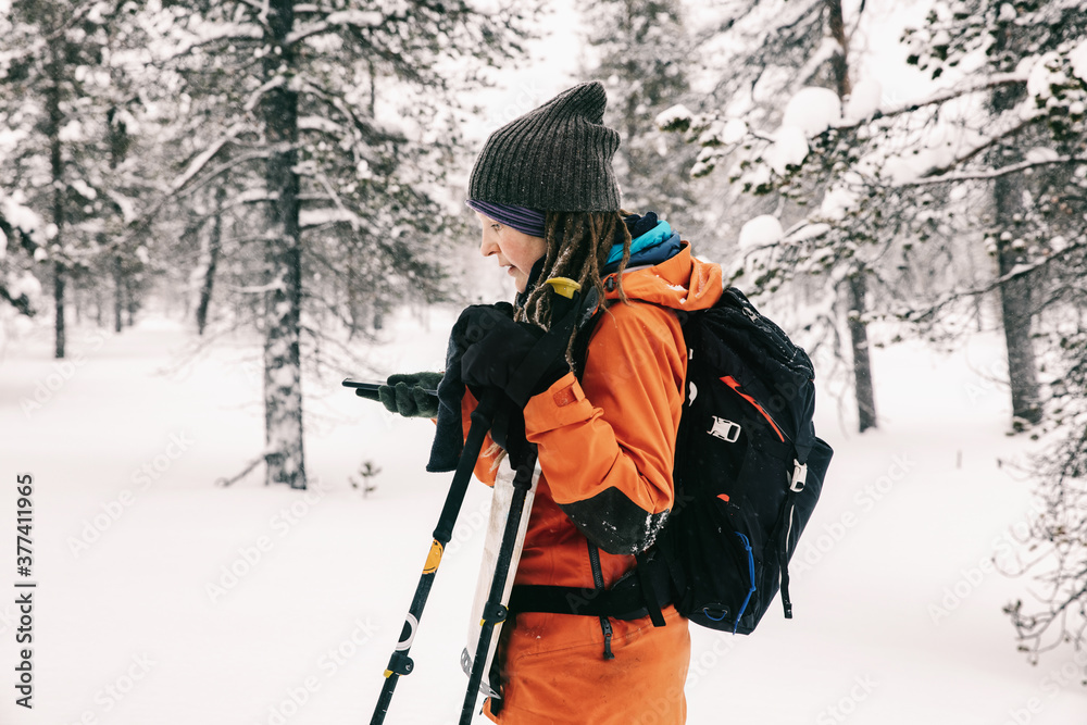 Woman Skier Using Cellphone For Orientation Woman Skier Using Cellphone For Orientation