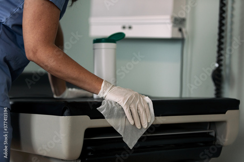 Exam: Anonymous Nurse Sanitizes Exam Table