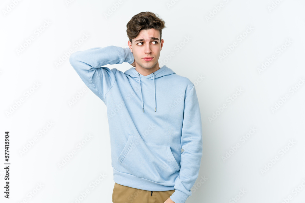 Young caucasian man isolated on white background touching back of head, thinking and making a choice. Young caucasian man isolated on white background touching back of head, thinking and making a choice.