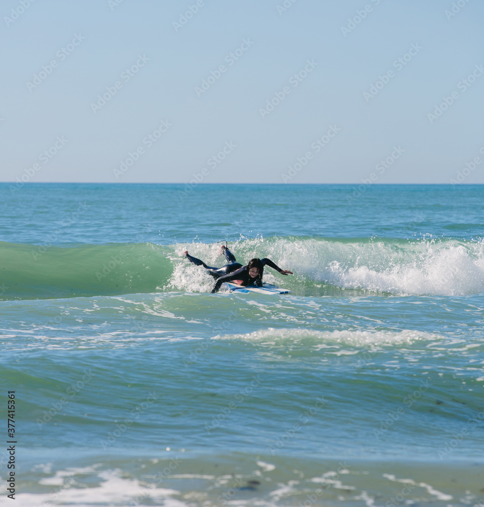 Surfer paddling a wave Surfer paddling a wave