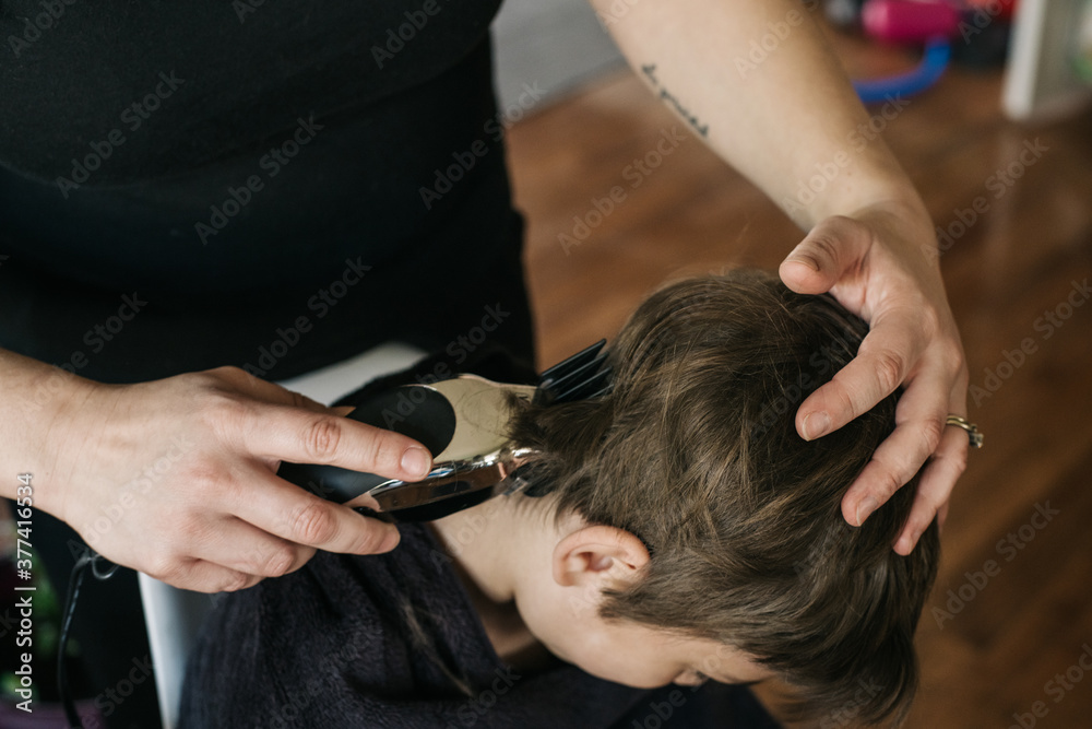 Boy getting his hair clipped at home Boy getting his hair clipped at home