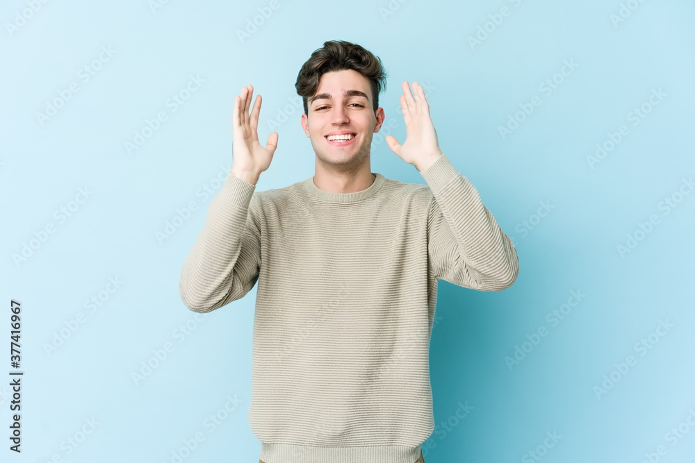 Young caucasian man isolated on blue background joyful laughing a lot. Happiness concept. Young caucasian man isolated on blue background joyful laughing a lot. Happiness concept.
