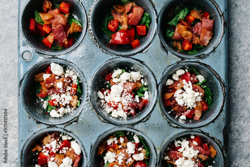 Muffin tin filled with ingredients for egg bites Stock Photo | Adobe Stock