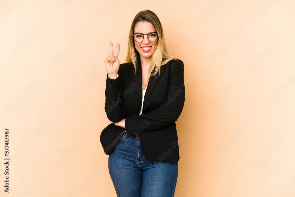 Middle age business woman isolated on beige background showing number two with fingers. Middle age business woman isolated on beige background showing number two with fingers.